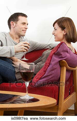 Stock Image - Couple relaxing with wine. Fotosearch