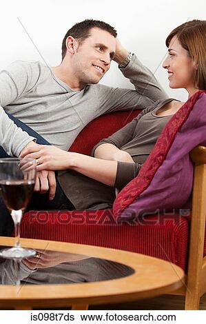 Couple relaxing with wine View Large Photo Image Stock Photograph - Couple relaxing with wine. Fotosearch