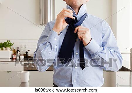 Man tying tie View Large Photo Image Stock Image - Man tying tie. Fotosearch
