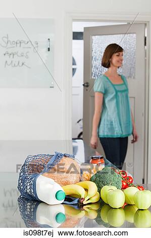 Woman and groceries in kitchen View Large Photo Image Stock Image - Woman and groceries in kitchen. Fotosearch