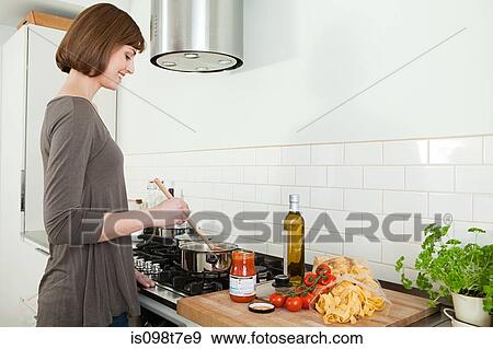 Woman cooking View Large Photo Image Stock Photo - Woman cooking. Fotosearch
