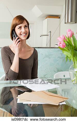 Woman on telephone with bills View Large Photo Image Stock Image - Woman on telephone with bills. Fotosearch