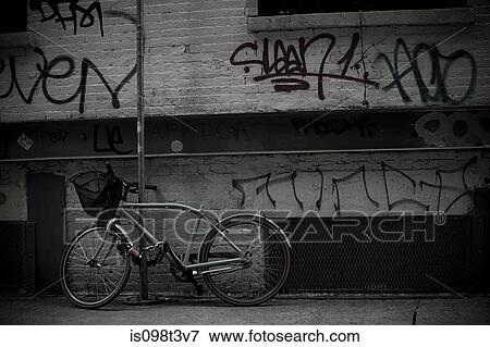 Stock Photo - Bicycle and graffiti on wall. Fotosearch