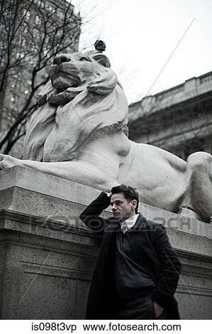 Man by lion statue at new york public library View Large Photo Image Stock Photography - Man by lion statue at new york public library. Fotosearch