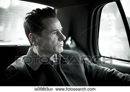 Stock Photo - Man in taxi cab. Fotosearch