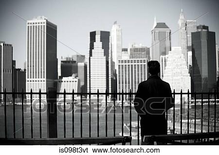 Man looking to lower manhattan from brooklyn heights promenade View Large Photo Image Stock Photograph - Man looking to lower manhattan from brooklyn heights promenade. Fotosearch