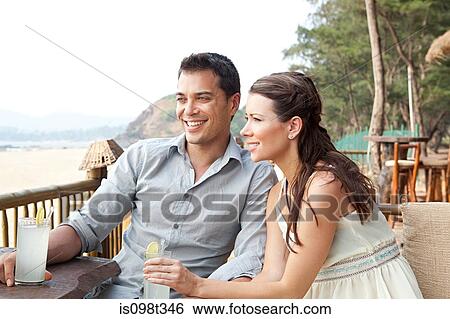 Couple at beach bar View Large Photo Image Stock Photograph - Couple at beach bar. Fotosearch