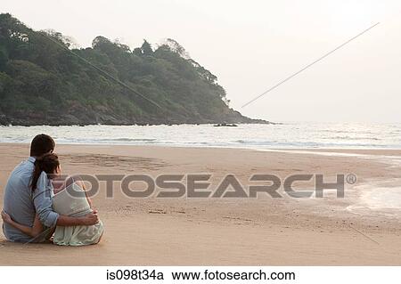 Couple looking out to the ocean View Large Photo Image Stock Image - Couple looking out to the ocean. Fotosearch