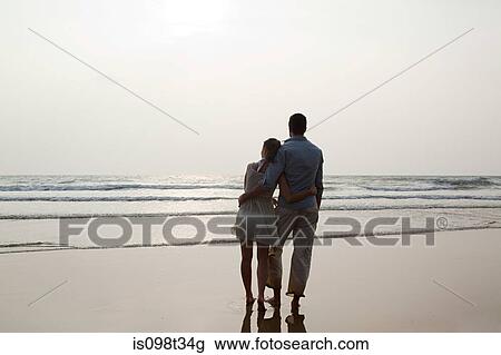 Couple looking out to the ocean View Large Photo Image Stock Image - Couple looking out to the ocean. Fotosearch