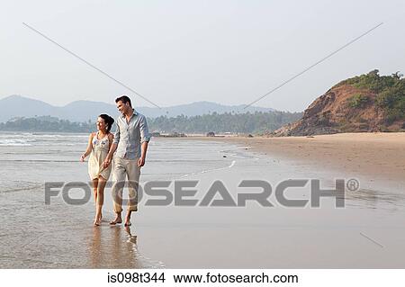 Couple walking in the sea View Large Photo Image Picture - Couple walking in the sea. Fotosearch