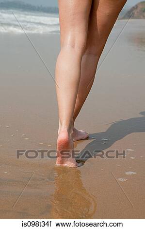 Legs of woman walking on wet sand View Large Photo Image Stock Image - Legs of woman walking on wet sand. Fotosearch