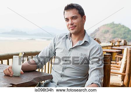 Man at beach bar View Large Photo Image Stock Image - Man at beach bar. Fotosearch