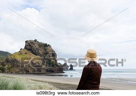 Senior woman on Piha Beach, Auckland View Large Photo Image Stock Image - Senior woman on Piha Beach, Auckland. Fotosearch