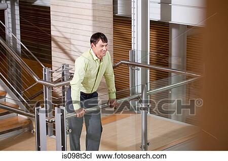 Businessman on stairwell View Large Photo Image Stock Image - Businessman on stairwell. Fotosearch