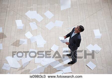 Stock Image - Businessman throwing papers. Fotosearch