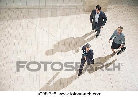 Businesspeople running in lobby View Large Photo Image Stock Photography - Businesspeople running in lobby. Fotosearch