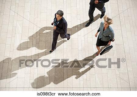 Businesspeople running in lobby View Large Photo Image Stock Photography - Businesspeople running in lobby. Fotosearch