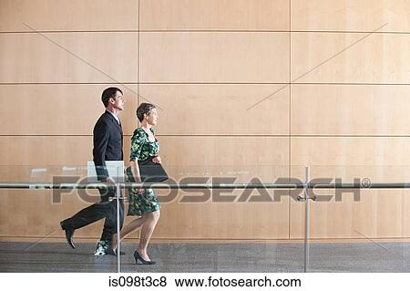 Businesspeople running through corridor View Large Photo Image Stock Photo - Businesspeople running through corridor. Fotosearch