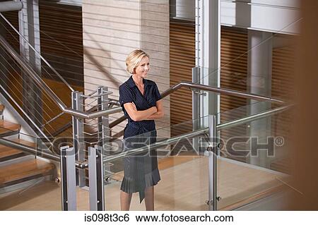 Businesswoman on stairwell View Large Photo Image Stock Photograph - Businesswoman on stairwell. Fotosearch