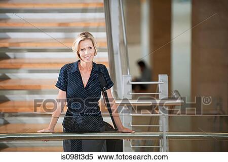 Businesswoman on stairwell View Large Photo Image Stock Photography - Businesswoman on stairwell. Fotosearch