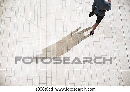 Businesswoman running in lobby View Large Photo Image Stock Image - Businesswoman running in lobby. Fotosearch