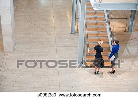 Businesswomen by stairwell View Large Photo Image Stock Image - Businesswomen by stairwell. Fotosearch