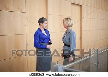 Stock Image - Businesswomen talking. Fotosearch