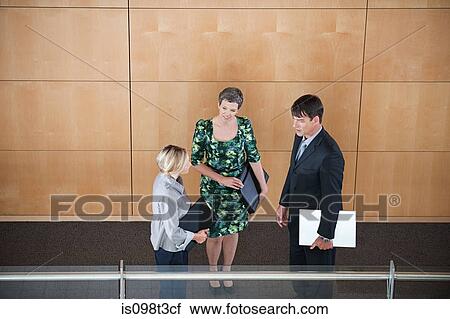 Stock Image - Colleagues in corridor. Fotosearch