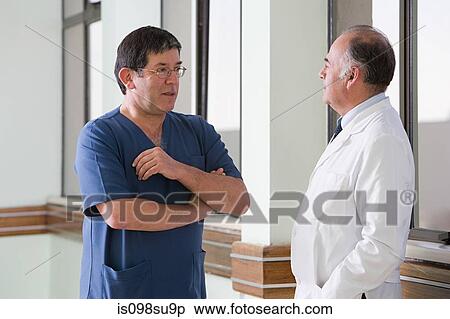 Doctor and surgeon talking View Large Photo Image Stock Photography - Doctor and surgeon talking. Fotosearch