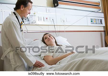 Doctor and young woman in hospital View Large Photo Image Stock Photo - Doctor and young woman in hospital. Fotosearch
