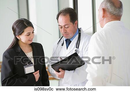 Stock Image - Doctors having discussion. Fotosearch