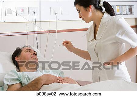Stock Image - Nurse taking temperature of patient. Fotosearch