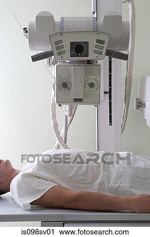 Stock Image - Patient and x-ray machine. Fotosearch