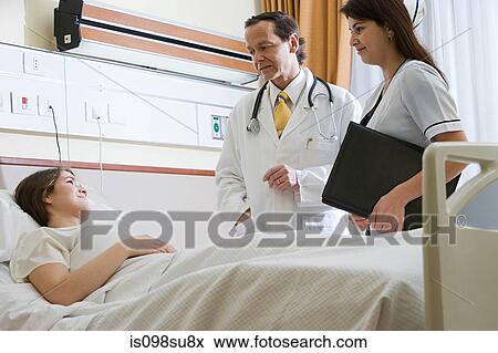 Young woman in hospital with doctor and nurse View Large Photo Image Stock Photo - Young woman in hospital with doctor and nurse. Fotosearch