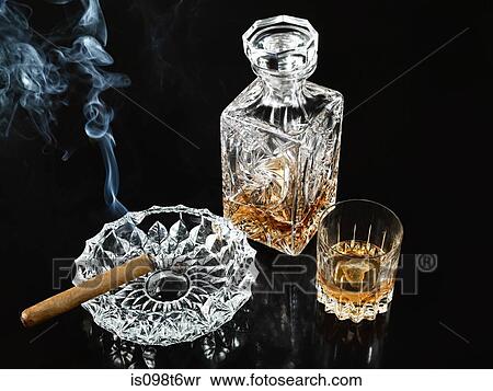 Cigar in ashtray with decanter and tumbler of whiskey View Large Photo Image Stock Photography - Cigar in ashtray with decanter and tumbler of whiskey. Fotosearch