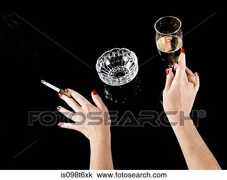 Female hand with cigarette in holder and glass of champagne View Large Photo Image Stock Image - Female hand with cigarette in holder and glass of champagne. Fotosearch