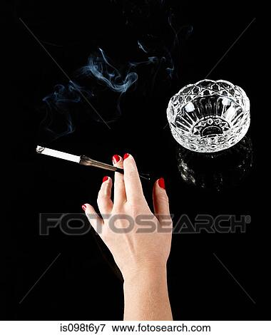 Female hand with cigarette in holder and ashtray View Large Photo Image Stock Photo - Female hand with cigarette in holder and ashtray. Fotosearch
