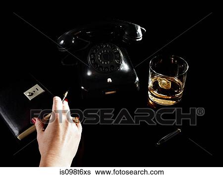 Female hand with notebook, telephone and glass of whiskey View Large Photo Image Stock Photograph - Female hand with notebook, telephone and glass of whiskey. Fotosearch