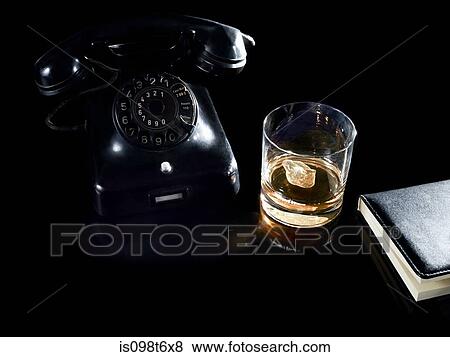Glass of whiskey by telephone View Large Photo Image Stock Photo - Glass of whiskey by telephone. Fotosearch