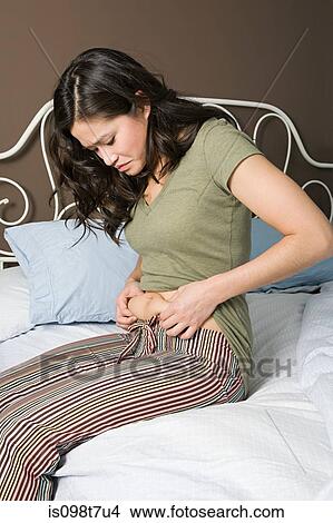 Picture - Body conscious young woman. Fotosearch