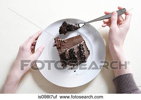 Young woman eating chocolate cake View Large Photo Image Stock Image - Young woman eating chocolate cake. Fotosearch