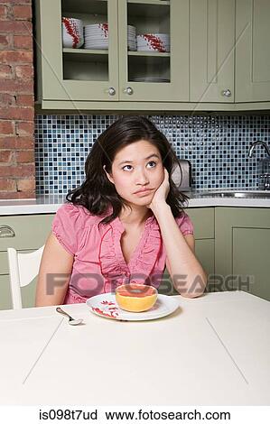 Young woman eating grapefruit View Large Photo Image Stock Image - Young woman eating grapefruit. Fotosearch