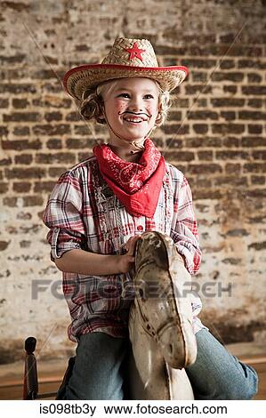Young girl dressed as cowgirl with rocking horse View Large Photo Image Stock Photo - Young girl dressed as cowgirl with rocking horse. Fotosearch