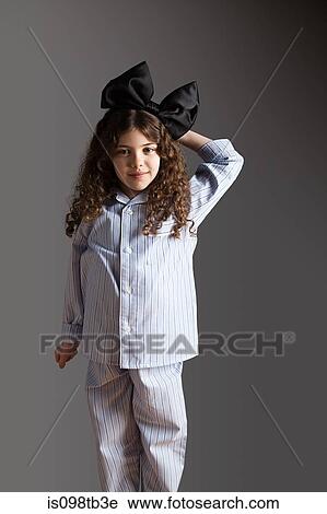 Young girl dressed in pyjamas with black hair bow View Large Photo Image Stock Image - Young girl dressed in pyjamas with black hair bow. Fotosearch