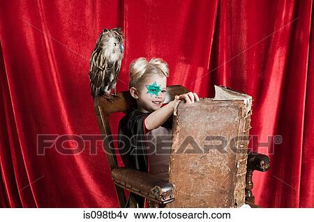 Young girl dressed up as wizard reading spell book View Large Photo Image Stock Photo - Young girl dressed up as wizard reading spell book. Fotosearch