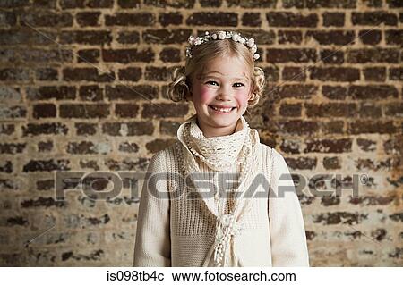 Stock Image - Young girl wearing flowers in hair. Fotosearch