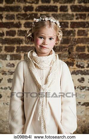 Stock Image - Young girl wearing flowers in hair. Fotosearch
