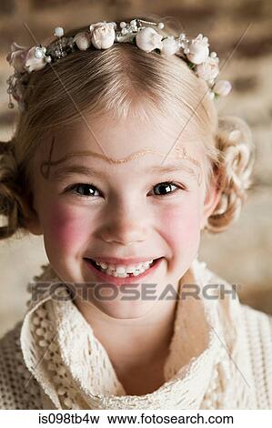 Young girl wearing flowers in hair View Large Photo Image Stock Photo - Young girl wearing flowers in hair. Fotosearch