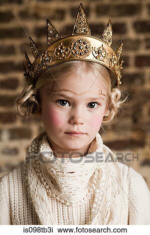 Stock Image - Young girl wearing gold crown. Fotosearch