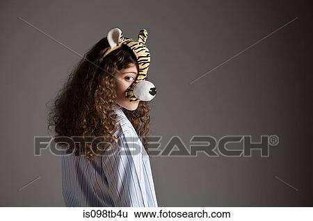 Young girl wearing tiger mask View Large Photo Image Stock Photograph - Young girl wearing tiger mask. Fotosearch